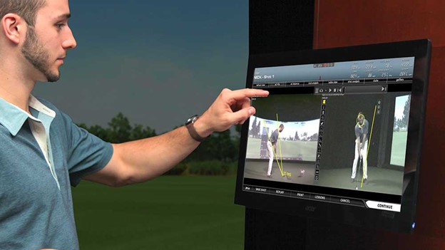 A customer tracks his swing using the aboutGOLF simulator software at Ethos Golf
