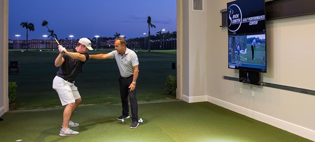 Rick Smith instructing a student on their swing